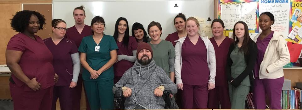 Students in the Personal Support Worker program stand smiling with guest Andrew Olivier